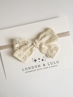 the london and luu headband with love & magic logo is shown on top of an envelope