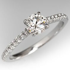 a diamond engagement ring on a white background