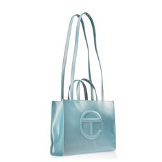 Brand New New Color Alert : Blue Ray Iconic Unisex Shopping Bag Is An Everyday Bag For Everyone. Featuring A Double Strap (Handles And Cross-Body Straps), Embossed Logo, A Main Compartment With Magnetic Snap Closure And Internal Zipper Pocket. Made From Faux Leather And Twill Lining. Bag Is Packaged In A Drawstring Bag With Screen-Printed Logo. Medium Fits A Laptop + Your Daily Survival Kit. Materials 50% Polyurethane, 50% Polyester Dimensions Height 11 1/4", Width 15", Depth 5", Strap Drop 21", Blue Shoulder Bag For Shopping With Dust Bag, Designer Light Blue Shopping Bag, Designer Light Blue Shoulder Bag For Shopping, Light Blue Shopping Bag, Light Blue Tote Bag For Evening, Light Blue Evening Tote Bag, Telfar Shopping Bag, Body Straps, Diesel Bag