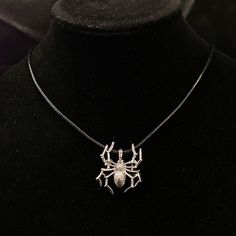 "This is a gorgeous silver spider pendant. Perfect for a goth look, for Halloween, or just because you love spiders! It is hung from a black faux leather woven waxed cord that is 19 1/2\" long, with silver chain and a silver lobster claw clasp. Make sure to check out my shop for more hair pins, jewelry, accessories, and all sorts of fun stuff! Spider Hair Comb, Silver Spider, Goth Hair Pins, Spider Jewelry, Arachnid Hair Combs, Halloween Spiders, Halloween Jewelry" Silver Charms Necklace For Halloween, Silver Halloween Charms Necklace, Gothic Halloween Jewelry With Round Pendant, Silver Halloween Charms Jewelry, Silver Halloween Jewelry With Charms, Halloween Silver Charm Jewelry, Gothic Halloween Round Pendant Jewelry, Silver Round Pendant Necklace For Halloween, Halloween Party Pendant Jewelry