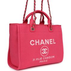 This small Deauville Shopping Tote is of hot pink canvas with light gold tone hardware, featuring a large CC signature and Chanel logo on the front, removable pouch and interwoven light gold tone chainlink and hot pink leather shoulder straps and two leather top handles.The interior is lined in beige linen fabric and has two open pockets on the front wall and a zipper pocket with a Chanel pull on the rear wall.Collection: 24C (RFID)Origin: ItalyCondition: New and never worn (plastic on hardware)Accompanied by: Chanel box, Chanel dustbag, carebook, retail UPC, RFID, removable pouch and ribbonMeasurements: 13" width x 10" height 5.75" depth; 3.5" top handle; 11" shoulder straps Travelling Bag, Lady D, Chanel Tote Bag, Pink Pouch, Chanel Box, Chanel Tote, Pink Canvas, Chanel Logo, Lighted Canvas