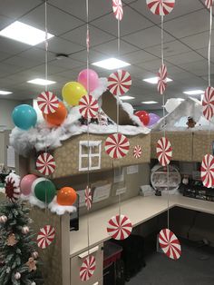 an office cubicle decorated for christmas with candy canes and snow on the ceiling