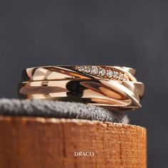 two wedding bands with diamonds on top of each other