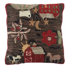 a decorative pillow with animals and farm scenes on it's side, in brown