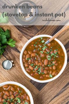 two white bowls filled with beans and parsley on top of a wooden cutting board