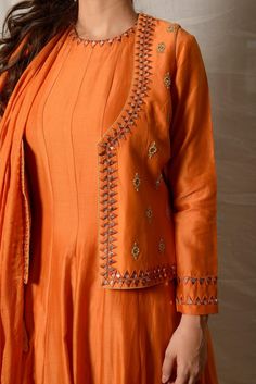 Elegant burnt orange embroidered chanderi suit with jacket and dupatta! The jacket is enhanced with delicate paat work. Shop designer Indian suits in USA from Pure Elegance. Disclaimer: The actual product may vary slightly from the image. These are custom orders, hence expect slight variation in color, placement of the motif or buta. ESTIMATED DELIVERYBecause this is a custom order, it would take about 4-6 weeks from the date of purchase. RETURN POLICYThis product is a custom order and cannot be returned or exchanged. Long Sleeve Chanderi Anarkali Set With Dori Work, Orange Kurta With Gota Work In Traditional Drape, Orange Chanderi Anarkali Set With Cutdana, Orange Semi-stitched Salwar Kameez With Cutdana, Festive Chanderi Nehru Jacket With Gota Work, Navratri Chanderi Nehru Jacket With Resham Embroidery, Orange Anarkali Set With Gota Work, Straight Kurta, Designer Wear Semi-stitched Chanderi Nehru Jacket, Designer Chanderi Semi-stitched Nehru Jacket