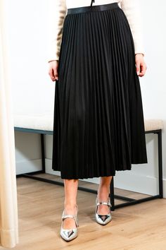 Get ready for an evening out with our Victoria skirt. Featuring a luxurious black accordion pleated design, this midi length skirt exudes elegance and refinement. Elevate any outfit with this chic and sophisticated piece. Elastic satin waistband Mary Grace is wearing XS/S with a 32B bust, 25” waist and 36” hip. 95% Polyester, 5% Spandex Hand wash cold and line dry