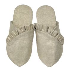 a pair of slippers with ruffles on the bottom and side, in light grey