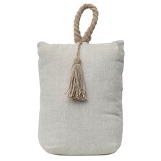 a white pillow with a rope handle and tassell on the inside of it