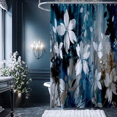 a shower curtain with flowers on it in a blue and white bathroom, next to a toilet