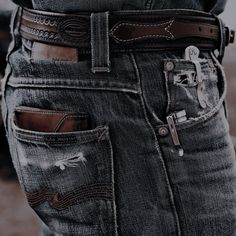 a person wearing jeans with holes in the back pocket