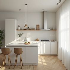 two stools are in front of the kitchen counter