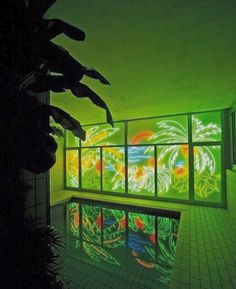 an indoor swimming pool lit up with colorful lights