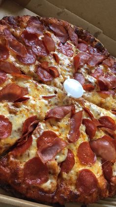 a pizza with pepperoni and cheese in a box