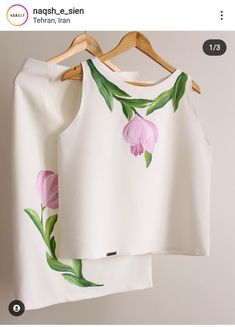 two white tops with pink flowers painted on them