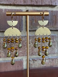 These beaded earrings are designed in a bohemian fringe style. You can definitely count on beautiful earring movements. These earrings are made of mustard yellow and spotted green Czech beads. All metal components are gold brass. The length of these earrings are about 3” long. Bohemian Gold Beaded Earrings With Ear Wire, Gold Bohemian Beaded Earrings With Ear Wire, Gold Bohemian Chandelier Earrings With Dangling Beads, Bohemian Gold Tassel Earrings With Round Beads, Gold Bohemian Tassel Earrings, Earthy Gold Dangle Earrings, Gold Artisan Beaded Earrings With Dangling Beads, Bohemian Gold Beaded Copper Earrings, Brass Dangle Earrings With Gold Beads