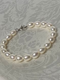 "Beautiful! Sterling Silver 925 & 9mm x 7mm Freshwater Pearl Bracelet.  Measures :  8\"L  Weight: 16.1  grams Stamped: 925 Condition : very good  Thank you for Visiting!" Classic Sterling Silver Bracelet With Polished Beads, Classic Sterling Silver Bracelet With 8mm Beads Gift, Classic Beaded Bracelets With Sterling Silver Clasp As Gift, Classic Charm Bracelet With Sterling Silver Clasp, Classic Sterling Silver Bracelet With Round Beads For Gifts, Classic Sterling Silver Beaded Bracelet For Gifts, Classic Sterling Silver Bracelet With Round Beads, Classic Sterling Silver Bracelet With Polished Beads As Gift, Elegant White Charm Bracelet With 8mm Beads