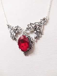 ◆ Necklace with bloody red crystal The crystal measures 0,984252 x 0,708661 inches and it is a deep red like the blood. This jewel is embellished with a silver plated filigree. All necklaces in my shop are adjustable in length, but if you have demanding details you can safely contact me! ❤ The product is handmade with great care. ♡ In my shop there are many handmade jewelry for sale for all tastes, come and look at them you are welcome! ♡ Ruby Red Necklace, Red Crystal Necklace, Necklace Ruby, Witch Necklace, Blue Crystal Necklace, Victorian Necklace, Necklace Gothic, Pagan Jewelry, Jewelry For Sale