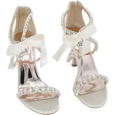 a pair of white shoes with bows and pearls