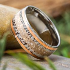 a wedding ring with wood and silver inlays