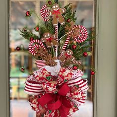 Gingerbread Christmas tree topper with Gingerbread men, gingerbread snowflakes, red bells, curlicues, white poinsettia and a coordinating designer bow will be the crowning achievement to your holiday tree! This topper is 45" from top ornament to the tip of the ribbons.  The bow is made from 4 different ribbons all in colors that coordinate with the top.  The bow is 14 inches wide and has eight ribbon streamers ranging from 18 inches length to 24 inches length. This handmade tree topper will be t Gingerbread Snowflakes, Ribbon Streamers, White Poinsettia, Gingerbread Christmas Tree, Christmas Tree Topper Bow, Handmade Tree, Tree Topper Bow, Gingerbread Christmas, Christmas Tree Topper