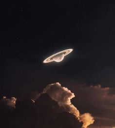 an object is flying in the sky above clouds