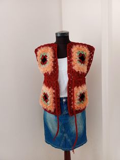 a mannequin wearing a red crocheted vest