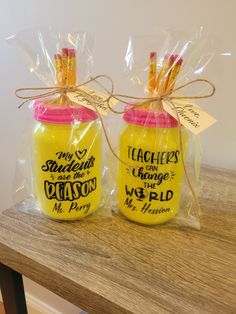 two yellow jars with pink lids are wrapped in plastic