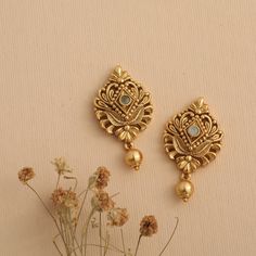 Description: Stud earrings are almost loved by everyone and can complement all face shapes. Stylish, floral comfort-wear; these features make this antique gold-plated stud earring so desirable and great for everyday use. With CZ stone and gold drop balls, these studs will be the new favorite of your collection. Details & Specifications: Materials used: Brass Alloy with Antique Plating Weight – 11.5 gm Length – 3.5 cm Make it custom Want to make it a custom earring? Sure! Reach out to us at suppo Earrings For Mom Indian, Earings Design Gold New Model, Gold Earrings For Women Indian, Gold Tops Earrings Indian, Gold Earrings Designs New Model, Jumkas Gold, Latest Gold Earrings, Small Earrings Gold, 22k Gold Earrings