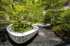 a large white planter sitting in the middle of a park