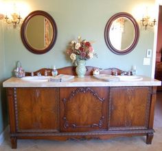 a bathroom with two sinks and mirrors on the wall