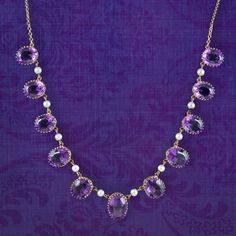 A majestic vintage dropper necklace adorned with eleven oval cut amethyst droppers with bright, white cultured pearls suspended in between. Each amethyst displays a luxurious deep violet hue and graduate in size from 2.2ct to 3.3ct in the middle (approx. 27ct total).  Amethyst is the birthstone of February and is considered a stone of protection, clarity and tranquillity. Its deep violet colouring has been highly esteemed throughout history, adorning regal jewellery all around the world, from an British Crown Jewels, Antique Jewellery Online, Diamond Chain Necklace, Diamond Chain, Antique Necklace, Minerals And Gemstones, Wedding Jewellery Necklace, Crown Jewels, Gold Pearl