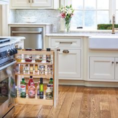 an open cabinet in the middle of a kitchen