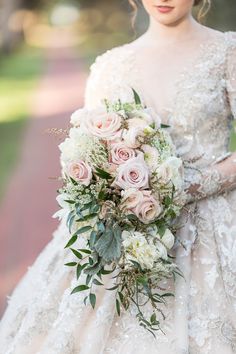 a woman in a wedding dress holding a bouquet