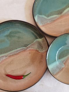 three plates with chili peppers painted on them