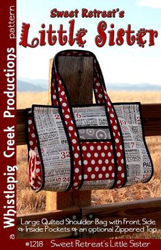 a book cover with a red and white polka dot purse hanging from a wooden fence