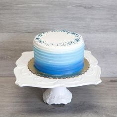 a blue and white cake sitting on top of a plate