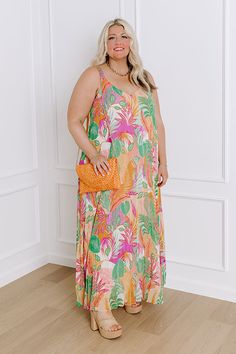 - Find me in the cabana in this tropical maxi! Embrace the carefree spirit of paradise with its flowing silhouette and cheerful hues, perfect for sun-soaked adventures or leisurely strolls along the beach. Let the playful patterns and airy design transport you to a world of endless sunshine and tropical bliss. - Pleated chiffon material with a pink, purple, ivory, orange, and green hued tropical botanical print - A built-in chiffon lining - A v-cut neckline and back - Adjustable spaghetti straps Beachy Maxi Dress With Tropical Print For Beach Cover-up, Summer Tropical Print Maxi Dress For Day Out, Summer Maxi Dress With Tropical Print For Day Out, Tropical Multicolor Dress With Palm Tree Print, Tropical Multicolor Palm Tree Print Dresses, Bohemian Sleeveless Maxi Dress With Tropical Print, Pink Flowy Maxi Dress For Beach Party, Beach Season Tropical Print Maxi Dress For Day Out, Tropical Print Maxi Dress For Beach Day Out