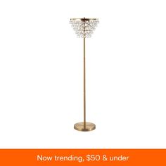 a floor lamp with the words now trending, $ 50 & under on it