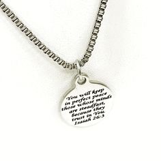 "This is Christian gift necklace that would work well for men. This necklace comes with a stainless steel laser engraved charm pendant on a 22 inch stainless steel box chain. The pendant is also available for individual purchase if you have another chain on which you would like to wear it. The pendant has \"You will keep in perfect peace those whose minds are steadfast because they trust in you\" from Isaiah 26:3 on it. Each necklace comes boxed and ready to give as a gift. This jewelry item has Inspirational Silver Jewelry With Customizable Engraving, Inspirational Silver Jewelry With Engraving Option, Meaningful Stainless Steel Jewelry For Father's Day, Father's Day Meaningful Stainless Steel Jewelry, Inspirational Nickel-free Stainless Steel Jewelry, Father's Day Stainless Steel Laser Engraved Jewelry, Inspirational Engraved Silver Charm Necklaces, Inspirational Engraved Silver Charm Necklace, Inspirational Silver Stainless Steel Necklaces