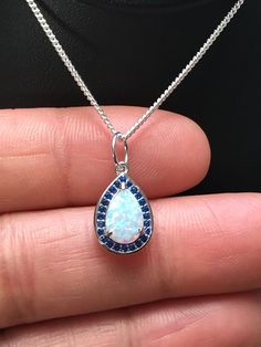 White Fire Opal and Blue Sapphire Pendant Necklace Metal: .925 Sterling Silver Stone: Lab created Opal and Blue Sapphire CZ Measurement: pendant height is approx. 15mm Choose Chain Length Please feel free to Convo me with any questions before purchasing. Please view policy before purchasing Other Opal Necklaces can be found here https://www.etsy.com/shop/LinksAndStones?ref=ss_profile&section_id=24284450 Thank You For Visiting My Shop Opal Necklaces, Sapphire Pendant Necklace, Blue Sapphire Pendant, Sapphire Necklace Pendants, Blue Sapphire Necklace, Fire Opal Necklace, Necklace Bridal, Sapphire Pendant, Necklace Blue