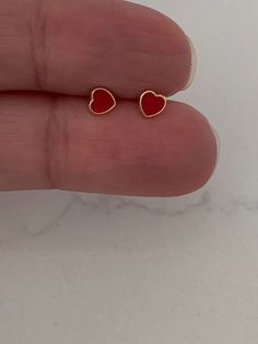 14K Solid Gold Red Heart Earrings | Dainty Red Hearts | Heart Stud Earrings | Red Earrings | Dainty Solid Gold Studs♦ Materials: 14K Gold♦ Available colors: Yellow Gold & Enamel ♦ Closure: Screw Backs♦ Earrings Measurements: Hearts are 5x5 Millimeters, please review the actual dimensions, since the photos have been enlarged. These earrings can be bought for toddlers or adults------------------------------------------------------------------------------------------PRODUCTION TIMESOrder processing Cheap Dainty Heart Earrings, Cheap Dainty Heart Earrings For Pierced Ears, Red Heart Earring Stud, Cute Red Earrings, Stud Girl, Heart Piercing, Red Heart Earrings, Pink Studs, Gem Earrings