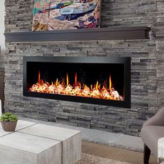 a modern fireplace in the middle of a living room with a painting on the wall