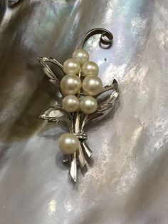 Vintage pearl bouquet brooch in silver 2.5 inches x 1.25 inches circa 1950's hallmarked silver. This is a stunning timeless piece of jewelry that has 8 real beautiful pearls attached to the silver leaves. This will be a great present to a classy woman who loves pearls. Pearl Bouquet, Bouquet Brooch, Silver Leaves, Brooch Bouquets, Vintage Pearl, Vintage Pearls, Classy Women, Silver Leaf, Timeless Pieces