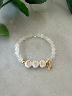 - The sweetest baby girl cross bracelet. Soft and delicate with dainty cross charm and personalized with name. Perfect goddaughter gift for baptism. Baby name bracelet is beaded on high quality stretch cord and secured.  - 4mm 18k gold filled accent beads   4.5mm gemstone beads ( white jade, rose quartz )   8mm cubic zirconia gold cross ‼️Young children MUST be supervised at all times while wearing jewelry. Contains small parts that could be a potential choking hazard. Jewelry should always be r Baby Beaded Bracelet, Hypoallergenic White Jewelry For Baptism, Personalized White Charm Bracelet For Birthday, Adjustable Silver Name Bracelet For Baptism, Personalized White Charm Bracelet, Adjustable, Adjustable White Bracelet For Confirmation, White Adjustable Bracelet For Confirmation, Personalized Adjustable White Charm Bracelet, White Personalized Adjustable Charm Bracelet