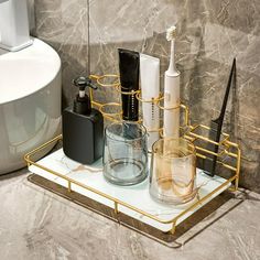 a bathroom shelf with toothbrushes and other items on it