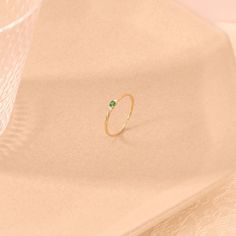 Elevate your style with this Emerald Minimal Solitaire Ring by Lucy Jewelry. Crafted in 14k solid gold, it features a dainty twisted band that leads to a brilliant emerald solitaire. This ring exudes elegance and sophistication, making it an ideal choice for a promise ring, engagement ring, or a unique addition to your jewelry collection. The ring can be made with yellow, rose, or white gold, please choose your size from the dropdown menu options above. 𝐑𝐢𝐧𝐠 𝐃𝐞𝐭𝐚𝐢𝐥𝐬 ❥ Solid gold, avai Stackable Yellow Gold Emerald Ring For Promise, Adjustable 14k Gold Emerald Ring, Yellow Gold Stackable Emerald Ring For Promise, 14k Gold Green Jewelry With Single Diamond, 14k Gold Ring With May Birthstone Diamond, 14k Gold Emerald Birthstone Ring, 14k Gold Single Diamond Ring For May Birthstone, 14k Gold Emerald Ring With Single Diamond For Promise, May Birthstone Ring With Single Diamond In 14k Gold