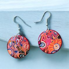 These earrings are one of a kind hand painted paper earrings with cute flower embelishments.  They are coated with quality UV resin. Very light weight!  Earrings come with high quality nickel free hypoallergenic earring hooks. Colorful Hand-painted Drop Earrings, Colorful Hand Painted Drop Earrings, Hand Painted Resin Earrings In Whimsical Style, Whimsical Hand Painted Resin Earrings, Bohemian Multicolor Hand Painted Flower Earrings, Handmade Colorful Flower Drop Earrings, Artsy Hand Painted Flower Earrings, Hand Painted Pink Resin Earrings, Colorful Handmade Flower Earrings Gift