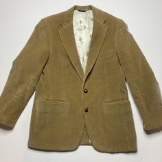 This Vintage Chaps Ralph Lauren Blazer Is A Classic Addition To Any Wardrobe. Made Of Brown Cotton Corduroy, This Sport Coat Features A Single-Breasted, Two-Button Front And A Notch Lapel Style. The Blazer Has A Regular Fit And A Chest Size Of 40. It Includes Inner Pockets And A Single Vented Back, With A Length That Falls At A Regular Jacket/Coat Length. Perfect For Any Occasion, This Blazer Is Versatile And Can Be Worn To Travel, Weddings, Parties, Casual Or Formal Events, And Business Meeting Semi-formal Cotton Blazer With Buttons, Winter Cotton Sport Coat With Suit Collar, Elegant Brown Cotton Outerwear, Classic Spring Button-up Sport Coat, Brown Sport Coat For Semi-formal Spring Events, Beige Cotton Blazer With Suit Collar, Brown Sport Coat With Button Closure For Spring, Elegant Single Breasted Corduroy Outerwear, Spring Brown Sport Coat With Button Closure