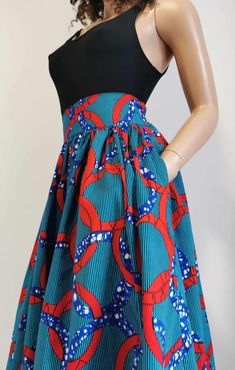 Handmade Unlined African Print Skirt     Elastic waist band skirt at the back      2 open side-entry pockets     Exact length: 32"      100% Wax Cotton     Handmade     Made in UK (Colours may vary due to lighting on images. The product images are closest to the true colour of the product.) Red Midi Skirt With Pockets, Red Knee-length Skirt With Pockets, Cotton Midi Skirt With Side Pockets, Midi Skirt With Side Pockets, Red Full Skirt Bottoms With Pockets, Long Red Skirt With Pockets, Red Full Skirt With Pockets, Fitted Green Maxi Skirt With Pockets, Fitted Skort With Pockets And Flared Skirt